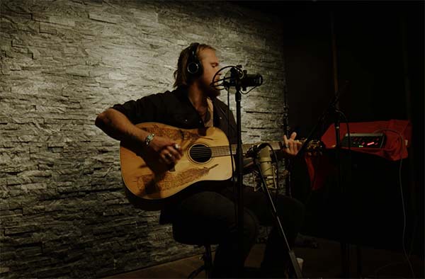 Jackson Dean singing in a recording studio